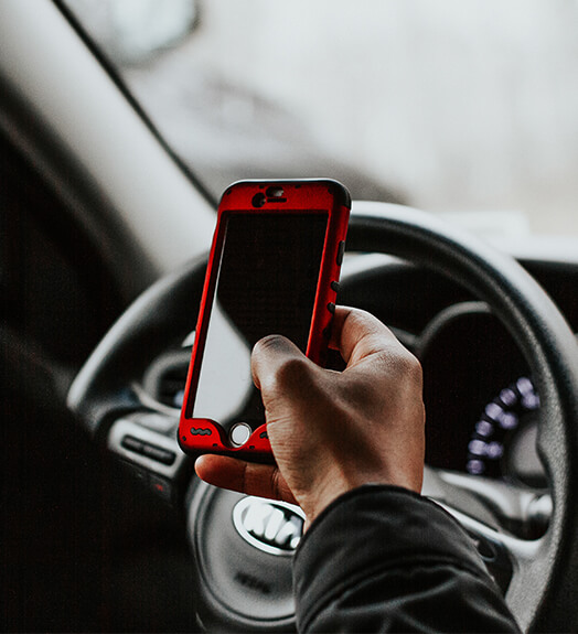 Uber driver inside a car holding his phone