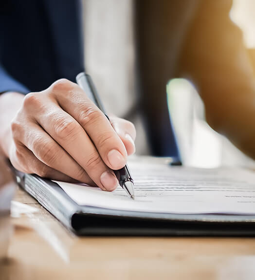 Lawyer's hand signing a contract