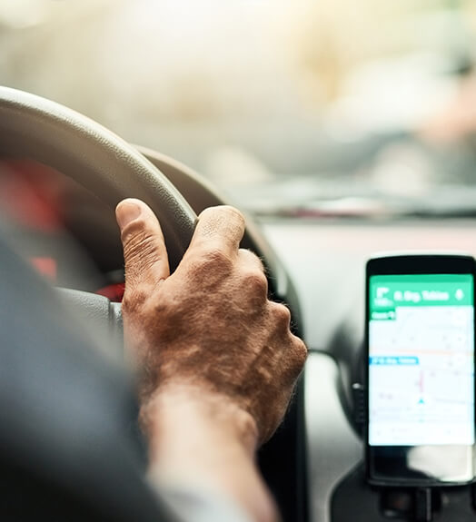 Ride-sharing service driver with navigation app on phone